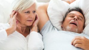 Man with Sleep Apnea Snoring Next to Spouse
